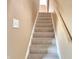 Carpeted stairs with simple wood railing at 1011 S Elm St, Muncie, IN 47302