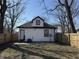 Back of the home featuring a fenced backyard with trees at 2869 Stuart St, Indianapolis, IN 46218