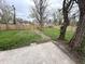 Large fenced backyard featuring mature trees and a concrete patio at 2869 Stuart St, Indianapolis, IN 46218