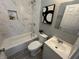 A bathroom features a white marbled shower, sink, toilet, and art piece at 2869 Stuart St, Indianapolis, IN 46218