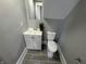 A small bathroom features a white sink, toilet, medicine cabinet, and plant at 2869 Stuart St, Indianapolis, IN 46218