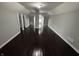 A large bonus room features wood floors and gray walls at 2869 Stuart St, Indianapolis, IN 46218