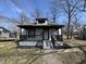 Charming home features a covered front porch with black railings and updated facade at 2869 Stuart St, Indianapolis, IN 46218