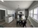 Modern kitchen features white cabinets, stainless steel appliances, and a dining area with views at 2869 Stuart St, Indianapolis, IN 46218