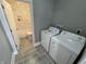 A laundry room features a new washer and dryer and tile floors at 2869 Stuart St, Indianapolis, IN 46218