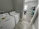 A laundry area features a new washer and dryer and tile floors at 2869 Stuart St, Indianapolis, IN 46218