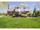 Lush backyard with a spacious lawn, complemented by a deck and patio seating area at the back of the house at 13668 Cheswick Blvd, Carmel, IN 46032