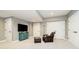 Cozy, carpeted basement with a comfortable chair and a television at 13668 Cheswick Blvd, Carmel, IN 46032