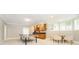 Spacious carpeted basement with a wet bar, table and chairs, and a ping pong table at 13668 Cheswick Blvd, Carmel, IN 46032