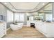 Bright bathroom features a soaking tub, double vanity, and white cabinets at 13668 Cheswick Blvd, Carmel, IN 46032