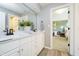 Bright bathroom features a double vanity with marble countertop and white cabinets at 13668 Cheswick Blvd, Carmel, IN 46032