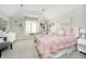 Cozy bedroom features a pink bed, carpet, and dresser at 13668 Cheswick Blvd, Carmel, IN 46032