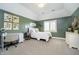 Bright bedroom with olive green walls, white trim, and carpet at 13668 Cheswick Blvd, Carmel, IN 46032