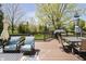 Inviting deck with comfortable seating, a dining table, and a grill, perfect for outdoor entertaining at 13668 Cheswick Blvd, Carmel, IN 46032