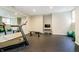 Home gym featuring a treadmill, weights, and rubber flooring at 13668 Cheswick Blvd, Carmel, IN 46032