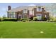 Stunning brick home with manicured lawn and lush landscaping at 13668 Cheswick Blvd, Carmel, IN 46032