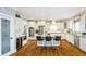 Bright kitchen with white cabinetry, stainless steel appliances, granite countertops, and a central island with bar seating at 13668 Cheswick Blvd, Carmel, IN 46032