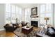 Bright living room with fireplace, large windows, and hardwood floors at 13668 Cheswick Blvd, Carmel, IN 46032