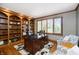 Cozy office with built-in bookshelves, natural light, and a large desk at 13668 Cheswick Blvd, Carmel, IN 46032