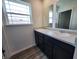 Well-lit bathroom featuring a double vanity, large mirrors, and modern fixtures with hardwood floors at 3202 W Longbranch Dr, Monrovia, IN 46157