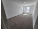 Spacious bedroom with plush carpet, white walls, and ample natural light, ideal for relaxation and personalization at 3202 W Longbranch Dr, Monrovia, IN 46157