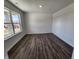 Bright bedroom with large window and modern wood-look flooring at 3202 W Longbranch Dr, Monrovia, IN 46157