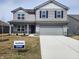 Charming two-story home featuring a gray exterior, a two-car garage, and a well-manicured lawn at 3202 W Longbranch Dr, Monrovia, IN 46157