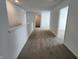 Bright hallway with soft carpet and white trim, seamlessly connecting different areas of the home at 3202 W Longbranch Dr, Monrovia, IN 46157