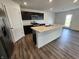Modern kitchen featuring stainless steel appliances, a center island, and dark cabinets at 3202 W Longbranch Dr, Monrovia, IN 46157