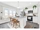 Modern kitchen with a granite island, stainless steel appliances, and a cozy window bench at 324 N Tacoma Ave, Indianapolis, IN 46201