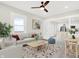 Bright living room featuring a ceiling fan and an open layout connecting to the modern kitchen at 324 N Tacoma Ave, Indianapolis, IN 46201