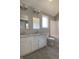 Bathroom featuring double sink vanity, granite countertop, large mirror, lighting, toilet and tub at 3725 Maple Ridge Trl, Columbus, IN 47201