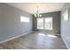 An empty dining room features new flooring, fresh paint, and bright windows at 3725 Maple Ridge Trl, Columbus, IN 47201