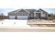 Charming gray home with a two car garage and beautiful stone accents at 3725 Maple Ridge Trl, Columbus, IN 47201