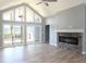 Bright open living space with a vaulted ceiling, modern fireplace and deck access at 3725 Maple Ridge Trl, Columbus, IN 47201