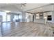 Open concept living space between a fireplace, modern kitchen, and doorway to outdoors at 3725 Maple Ridge Trl, Columbus, IN 47201