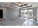 The primary bedroom features trey ceilings, a ceiling fan, and large windows at 3725 Maple Ridge Trl, Columbus, IN 47201