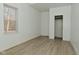 A bedroom with a closet, window, light-colored walls and modern floors at 3111 Station St, Indianapolis, IN 46218
