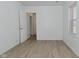 Bright bedroom featuring wood-look flooring and a sun-filled window at 3111 Station St, Indianapolis, IN 46218