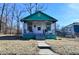 Charming exterior of a quaint, one-story home with a small porch and green trim at 3111 Station St, Indianapolis, IN 46218