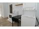 Bright kitchen featuring white appliances, countertops, and cabinets with a laundry area in the background at 3111 Station St, Indianapolis, IN 46218