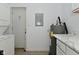 Bright kitchen featuring white appliances, countertops, and cabinets with a laundry area in the background at 3111 Station St, Indianapolis, IN 46218