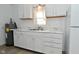 Bright kitchen featuring white appliances, countertops, and cabinets with a laundry area in the background at 3111 Station St, Indianapolis, IN 46218