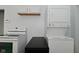 Efficient laundry area featuring stacked washer/dryer and adjacent electric range at 3111 Station St, Indianapolis, IN 46218