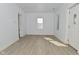 Bright living room with white walls, light hardwood floors, and natural light at 3111 Station St, Indianapolis, IN 46218