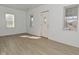 Bright living room with hardwood floors, white walls, and natural light from multiple windows at 3111 Station St, Indianapolis, IN 46218