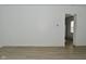 Open living room with light hardwood floors, white walls, and a view into the kitchen at 3111 Station St, Indianapolis, IN 46218
