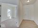 Inviting hallway with hardwood-style flooring, leading to a carpeted room with a window at 3568 Berkdale Dr, Columbus, IN 47203