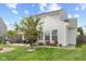 The private backyard features a patio, grill, seating area, mature trees and lovely landscaping at 3335 Hurst St, Whiteland, IN 46184