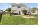 A verdant backyard with a built in fire pit and outdoor dining space is perfect for gatherings at 3335 Hurst St, Whiteland, IN 46184